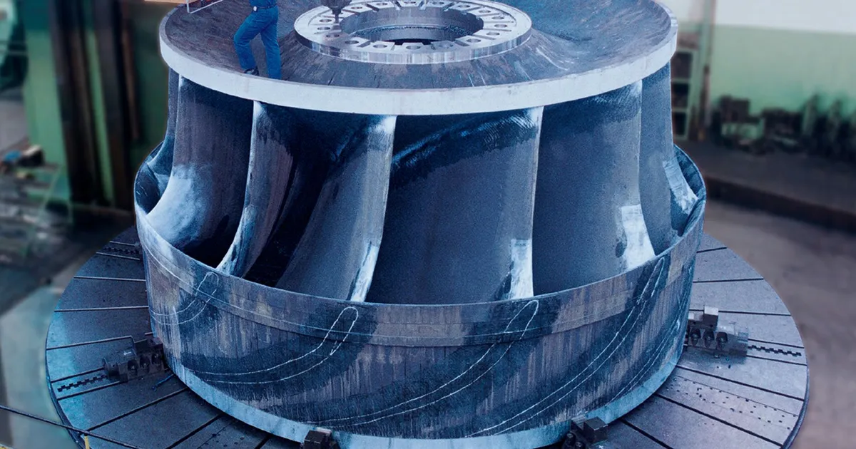 Francis turbine runner clamped on the table of a large turning lathe, an example of hydro turbine component machining