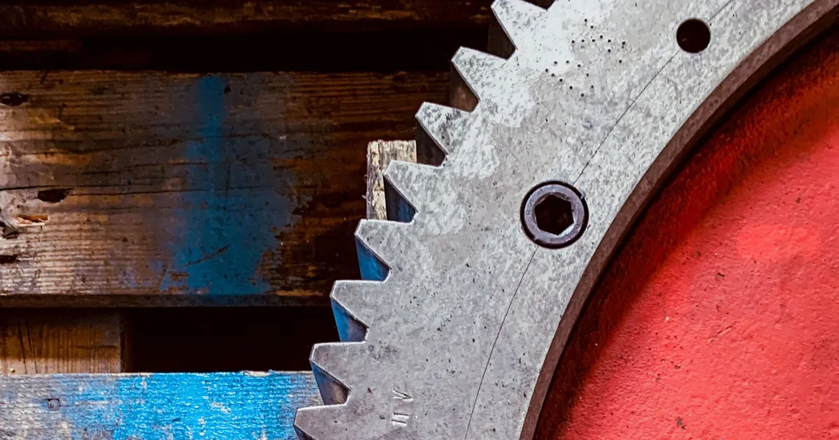 Close view of a large steel gear with cut teeth, the kind of part covered by large ring gear machining
